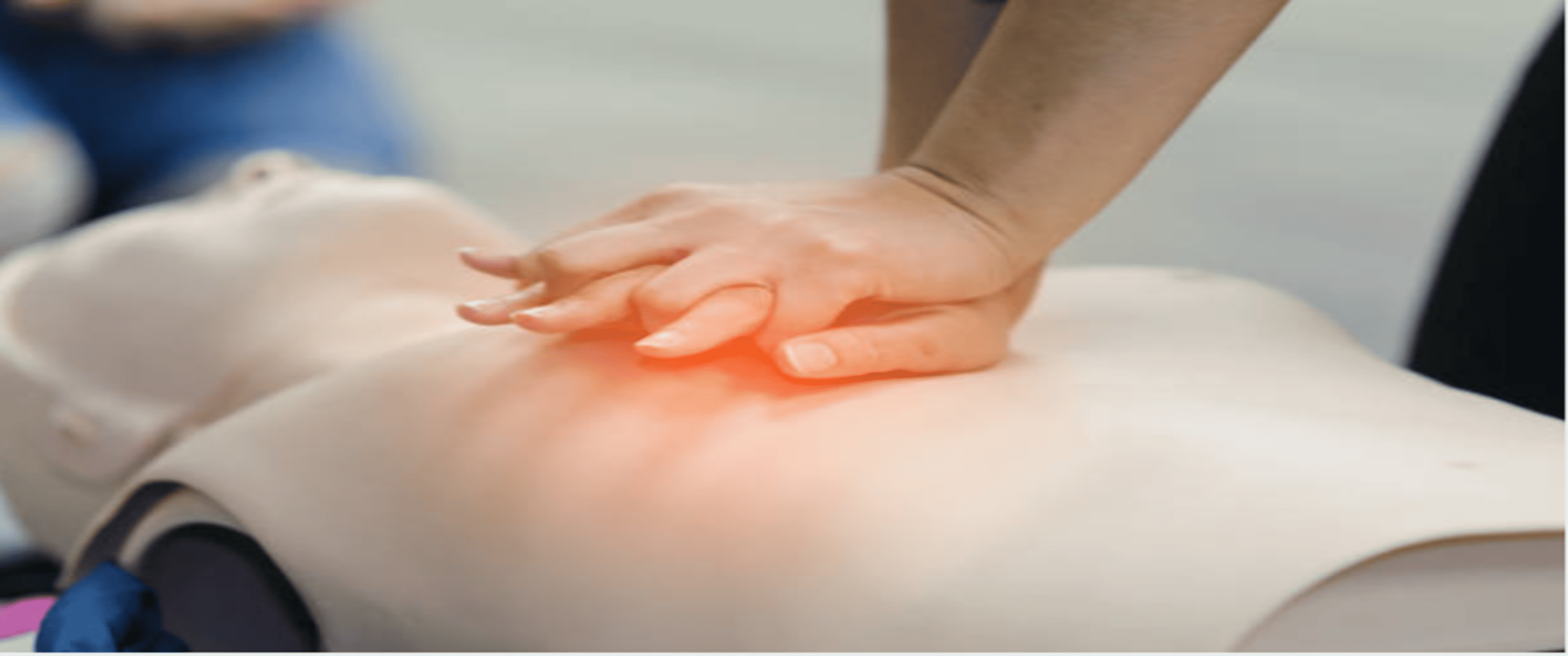 CPR mannequin with a person's hands on the chest